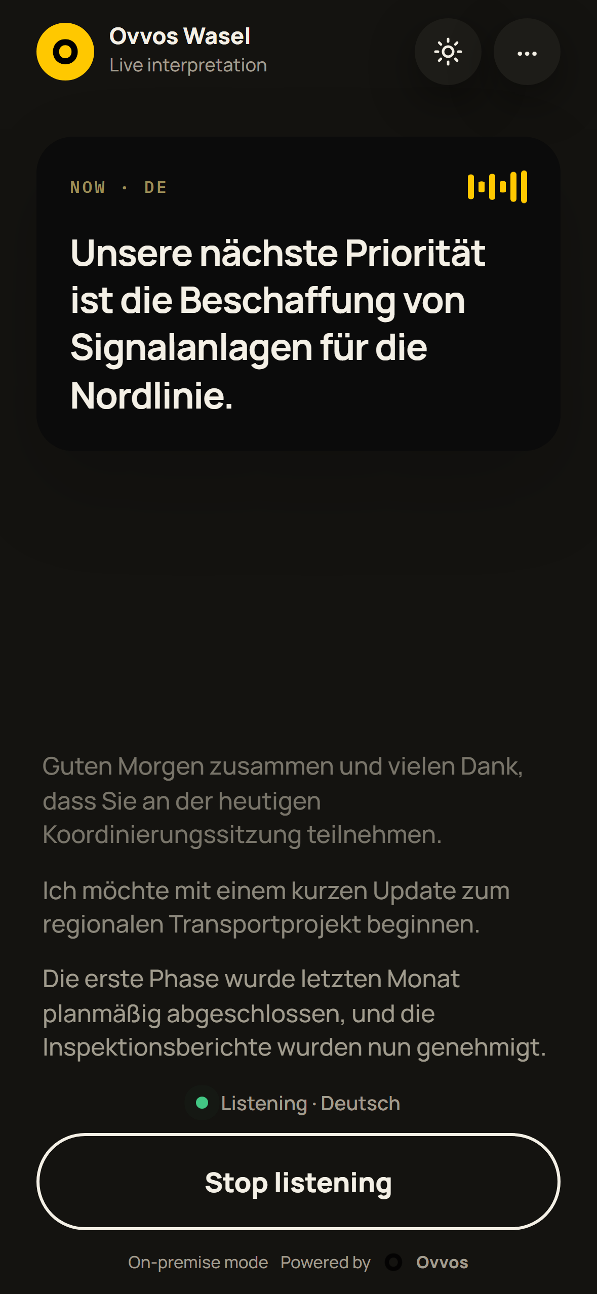 Phone in dark mode showing a live German caption